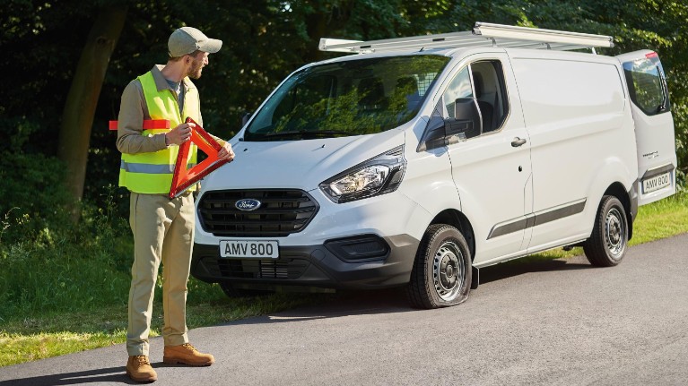 ford servicing eu feature 16x9 2160x1215 Modules man standing next to car on road side with warning triangle